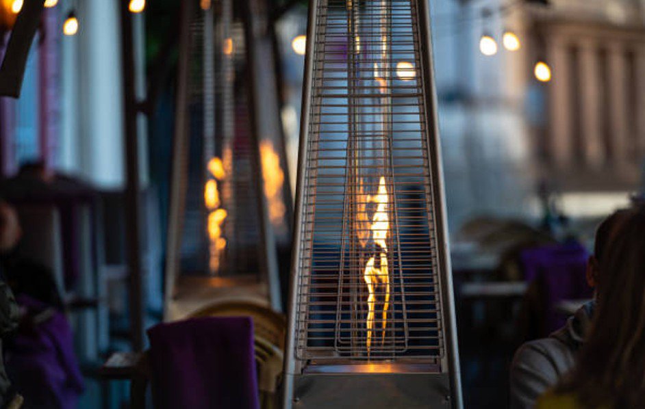 Outdoor patio heater with visible flame
