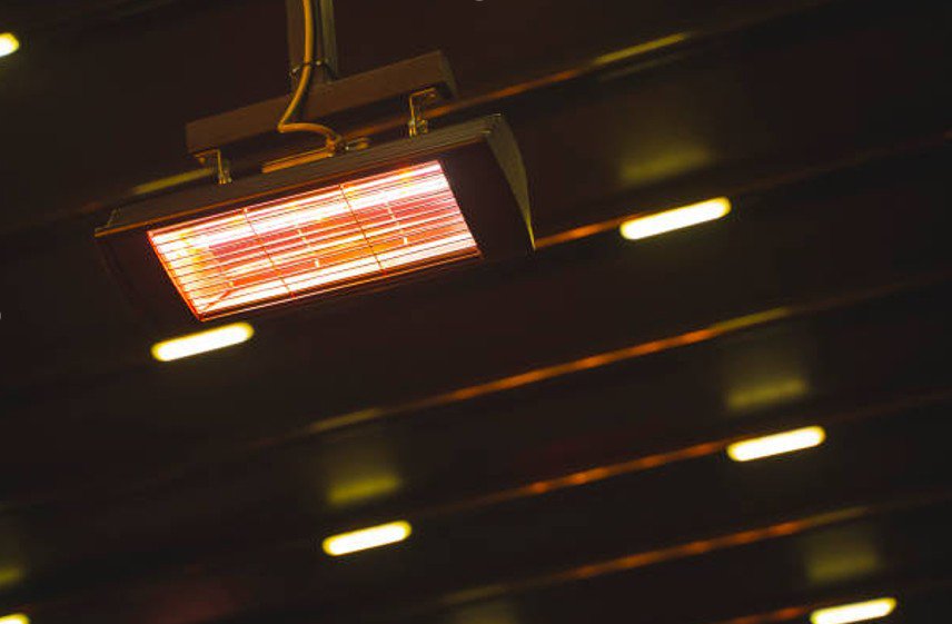 Ceiling-mounted infrared heater glowing in a commercial indoor space.