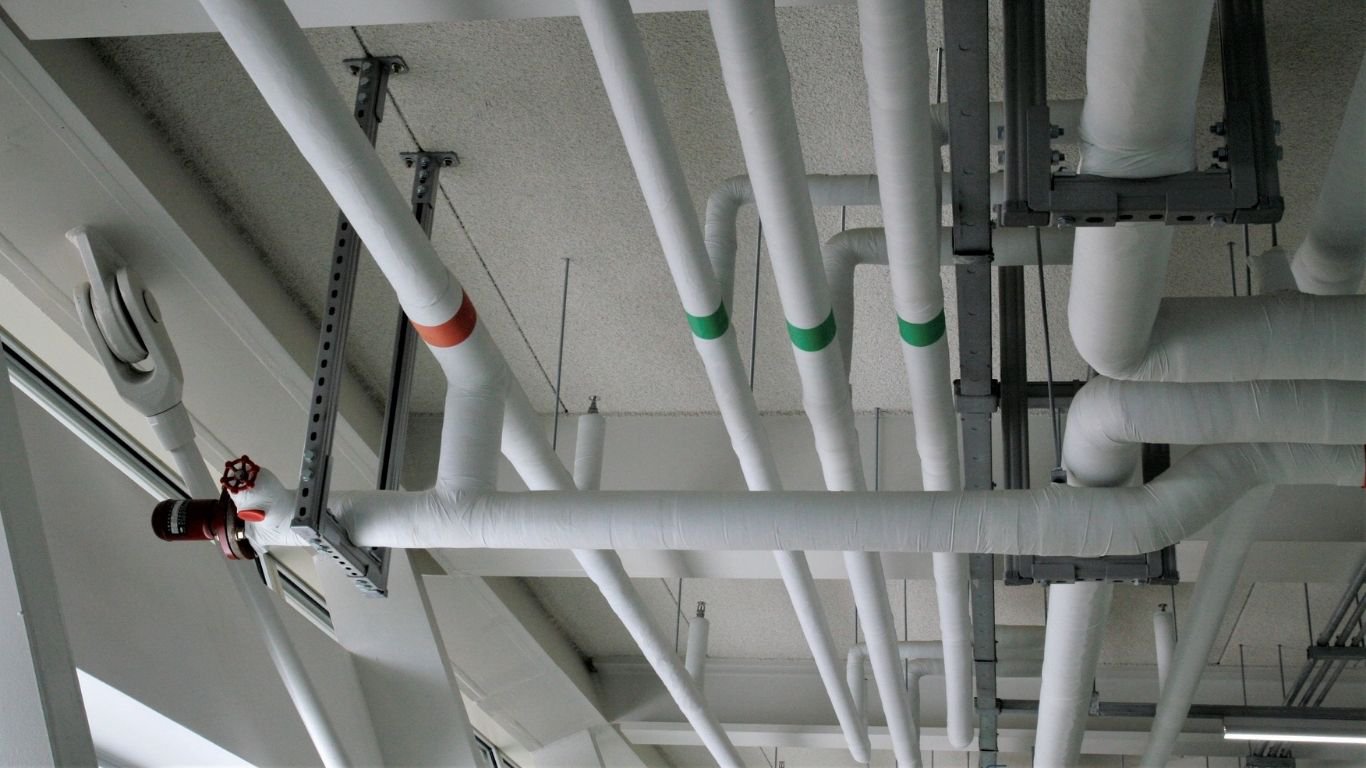 A set of pipes in a factory ceiling